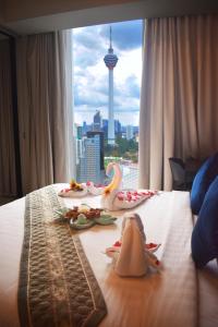 a hotel room with a table with food on it at Star Sky Park KLCC in Kuala Lumpur
