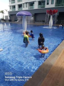 a group of children playing in a swimming pool at Nabiha Suites Bandar Baru Bangi in Bangi