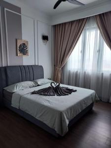 a bedroom with a bed and a window with curtains at Nabiha Suites Bandar Baru Bangi in Bangi