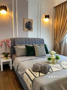 a bedroom with a large bed with a blue headboard at Nabiha Suites Vista Bangi Bandar Baru Bangi in Bangi