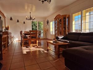 a living room with a table and a couch at Riumar 'Eva', 300m to beach, private pool, On-Site-Service, dog beach in Riumar