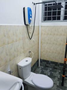 a bathroom with a toilet and a shower at 4 Bedroom House Indera Mahkota 8 Kuantan Homestay in Kuantan