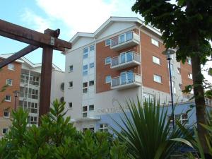 a large apartment building in front of a building at Spacious 2 Bed Perfect for City Centre & Bay, Pool, Gym in Cardiff