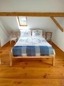 a bedroom with a bed with a blue and white comforter at Schlaf mal im Denkmal in Birstein