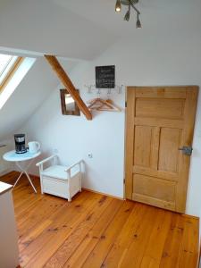 a room with a wooden door and a wooden floor at Schlaf mal im Denkmal in Birstein