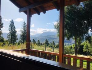 a window of a cabin with a view of the mountains at Cabaña de Montaña in San Martín de los Andes