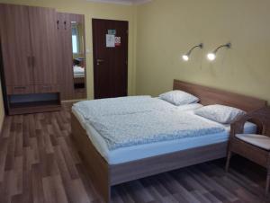 a bedroom with a bed and a table and a chair at GAS Truck centrum in Holíč