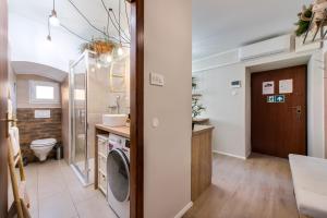 ein Badezimmer mit einem WC, einem Waschbecken und einer Waschmaschine in der Unterkunft City Center Studio Apartment for Humans & Pets - One in Rijeka