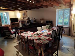 a dining room with a table and a christmas tree at La Maison de Musique in Nohant-Vic