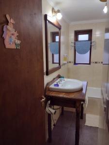 a bathroom with a sink and a mirror at El Rincón del Andino - Planta Baja in Ushuaia