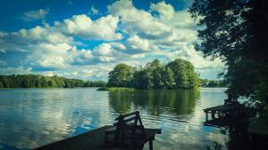 a view of a lake with a wooden dock at Haus Seeblick in Stary Gieląd