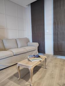 a living room with a couch and a coffee table at Raízes Turismo Rural in Castelo Branco