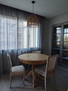 a dining room with a wooden table and chairs at Raízes Turismo Rural in Castelo Branco