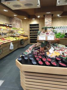 a produce section of a grocery store with fruits and vegetables at New Apartment near Champs Elysées in Paris