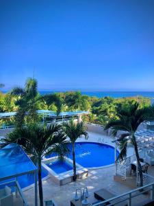 a view of the pool at a resort with palm trees at Daymond Blue Tropical Lodge in Santa Cruz de Barahona