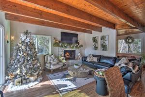 a living room with a christmas tree and a couch at Picturesque Cabin 2 Balconies, Walk to Lake! in Crestline