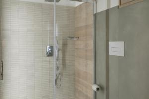 a bathroom with a shower with a glass door at Hotel Villa Cedrino in Dorgali
