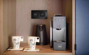 a coffee maker and two cups on a shelf at M-Street art lodging - Self check-in in Leuven