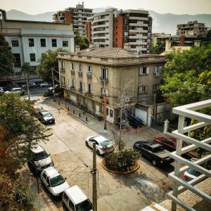 a parking lot with cars parked in a city at Apart Hotel Viva Providencia in Santiago