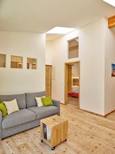 a living room with a couch and a table at WEINVIERTLER KELLERSTÖCKL Weingut Hindler in Schrattenthal