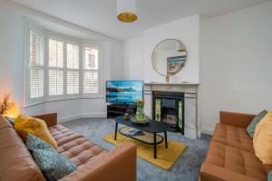 a living room with a couch and a fireplace at 3 Anzac Cottage in Cowes