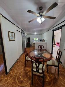 comedor con mesa y sillas y ventilador de techo en Casa Congo en Golfito