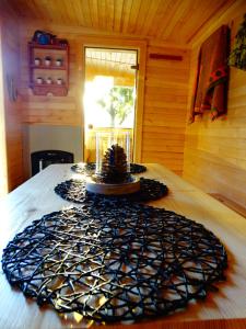 a wooden room with a table with a large mandala on it at Wysockie Zacisze in Osowa