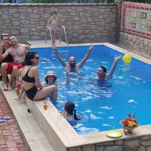 a group of people in a pool playing frisbee at Batumi Wonderland Guest House in Batumi