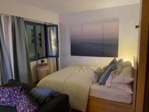 a bedroom with a bed with a tv on the wall at Cozy Renovated Studio located in centre of Benalmadena and Puerto Marina in Benalmádena