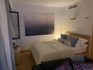 a bedroom with a bed and a large window at Cozy Renovated Studio located in centre of Benalmadena and Puerto Marina in Benalmádena