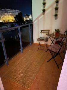 a balcony with a table and chairs and a view of a city at Cozy Renovated Studio located in centre of Benalmadena and Puerto Marina in Benalmádena