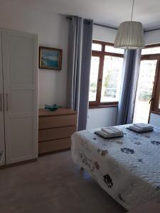 a bedroom with a bed and a window at Obzor Tatyana Apartaments Bonjour in Obzor