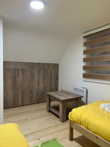 a room with a desk and a table in it at Vila Vodice Zlatibor in Vodice