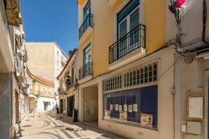 an alley in an old town with buildings at Setúbal Downtown Apartments in Setúbal
