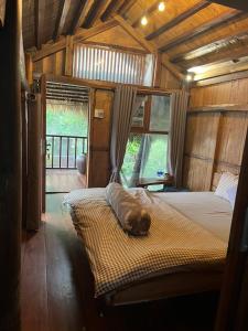 a dog sleeping on a bed in a room at Cat Homestay in Hue