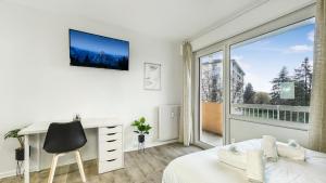 a white bedroom with a desk and a large window at HOMEY LA COLOC MUGI - Colocation haut de gamme - Chambres privées - Balcon - Wifi et Netflix - Proche transports commun in Annemasse