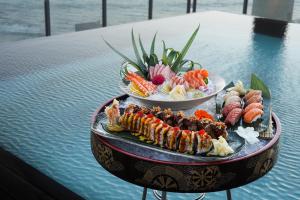 two plates of food on top of a table at Hotel Faro, a Lopesan Collection Hotel - Adults Only in Maspalomas