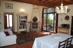 a living room with a table and a fireplace at Agriturismo Fattoria di Malavolta in Florence