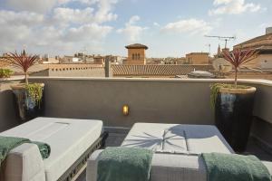 a balcony with two beds and a view of a city at Palma Riad - Adults Only in Palma de Mallorca