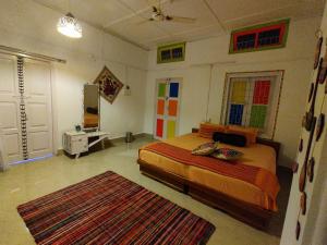 a bedroom with a bed and a rug at Gianna Homestay in Jorhāt