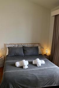 a bedroom with a bed with two pillows on it at SATUNA BEACH CASA in Begur