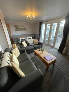 a living room with a couch and a coffee table at Self Catering Spacious 2 Bed Apartment with sea views in South Erradale