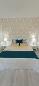 a bedroom with a large bed with two lamps at Park Apartments in Dnipro