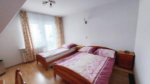 Posteľ alebo postele v izbe v ubytovaní Ceper Pokoje Gościnne