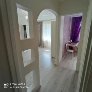an empty room with a hallway with a mirror at Park Apartments in Dnipro