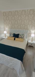 a bedroom with a large bed with two lamps at Park Apartments in Dnipro