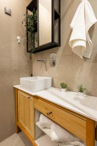 a bathroom with a white sink and a mirror at Old Port Riverside Apartments in City Center in Belgrade