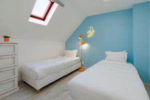 a bedroom with a bed and a dresser and a bed and a bedskirts at Good Vibes Apartment in Setúbal