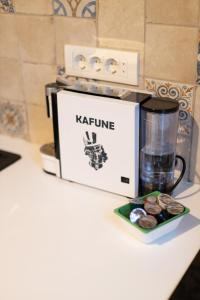 a coffee maker and a cup of water and a plate of cookies at Old Port Riverside Apartments in City Center in Belgrade