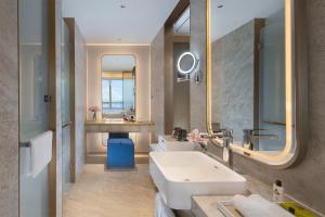 a bathroom with a sink and a mirror at Shenzhenair International Hotel in Shenzhen